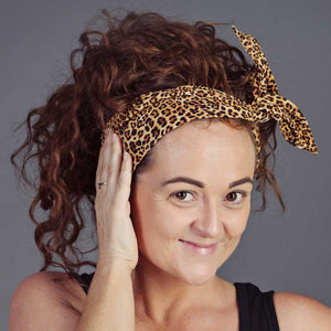 Model wearing an AntiCraft do rag, a wired head wrap in the twist style - wire hair accessories that fix bad hair days.